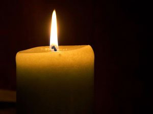 A candle in a dark room ready to be used for Tratak Sadhana